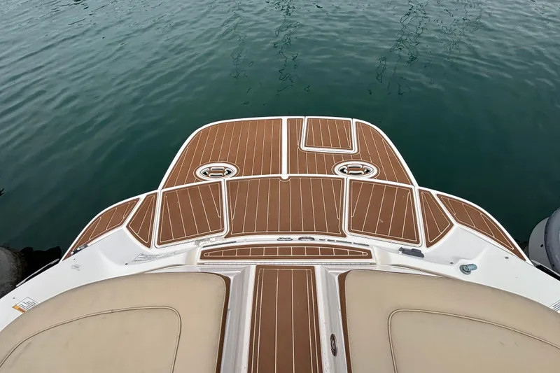 Slide: The Image of 2015 Sea Ray 300 SLX boat deck with teak flooring, overlooking calm water. - 9