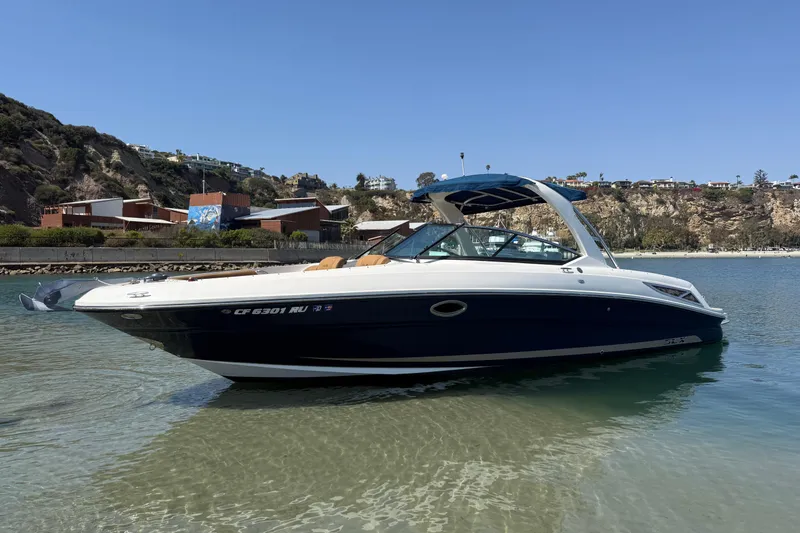 The Image of 2015 Sea Ray 300 SLX boat in calm waters near rocky shoreline. - 0