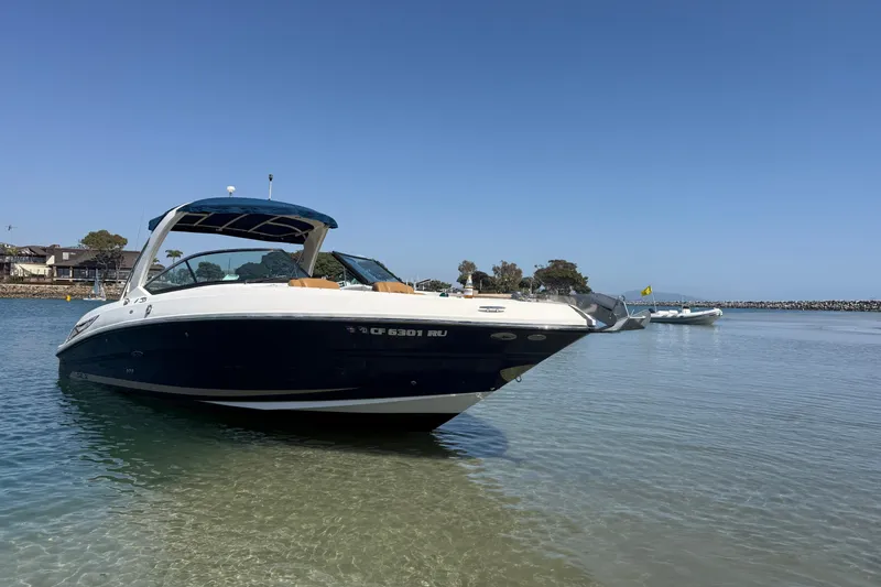 Slide: The Image of 2015 Sea Ray 300 SLX boat anchored in calm, shallow waters. - 1