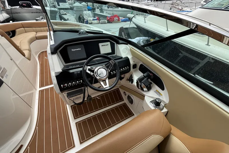 Slide: The Image of Interior view of 2015 Sea Ray 300 SLX boat cockpit with steering wheel and controls. - 5