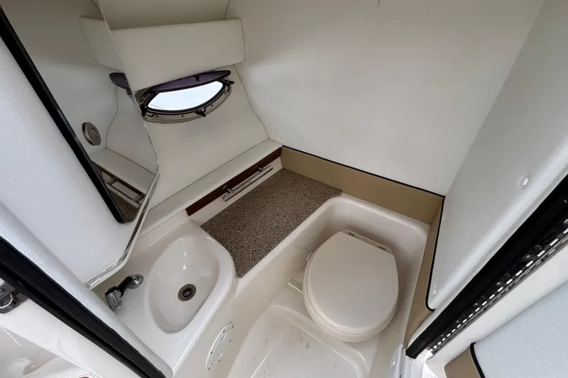 Slide: The Image of Interior of 2015 Sea Ray 300 SLX boat bathroom with sink, toilet, and porthole window. - 6