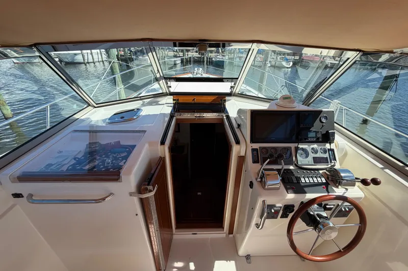 Slide: The Image of Cockpit view of 2000 Sabreline 36 Express boat with steering wheel and navigation controls. - 13