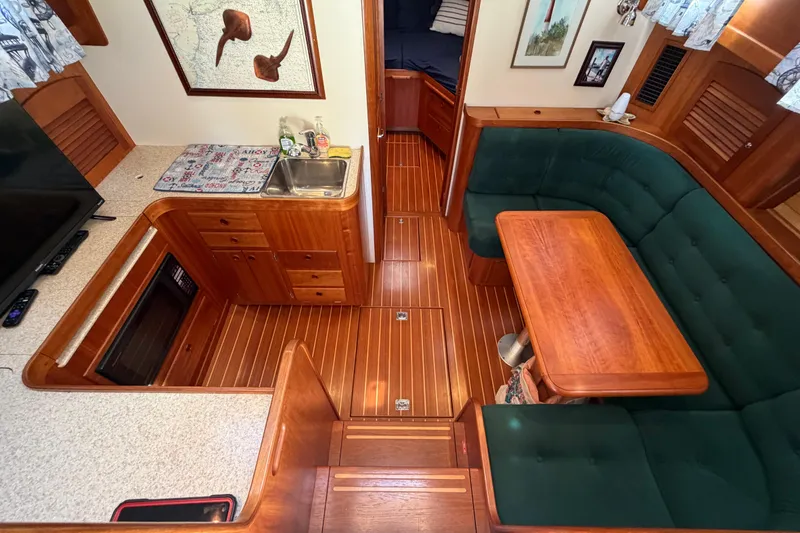 Slide: The Image of Interior of 2000 Sabreline 36 Express yacht with wood finish and green seating. - 14