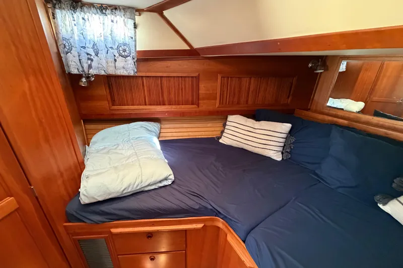 Slide: The Image of Cozy cabin interior of 2000 Sabreline 36 Express with wooden accents and nautical-themed decor. - 20