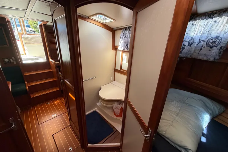 Slide: The Image of Interior of 2000 Sabreline 36 Express yacht, featuring cozy cabin and compact bathroom. - 26