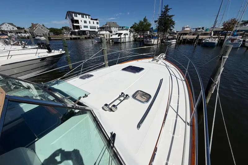 Slide: The Image of 2000 Sabreline 36 Express yacht docked at a marina, surrounded by other boats. - 29