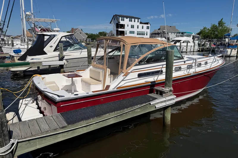 Slide: The Image of 2000 Sabreline 36 Express boat docked at a marina under clear blue skies. - 3