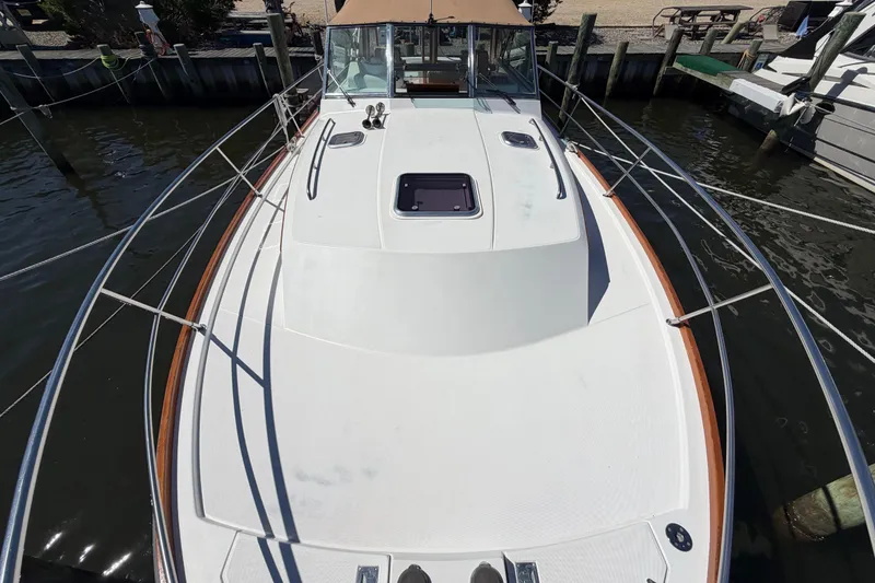 Slide: The Image of 2000 Sabreline 36 Express boat docked, showcasing spacious deck and sleek design. - 32