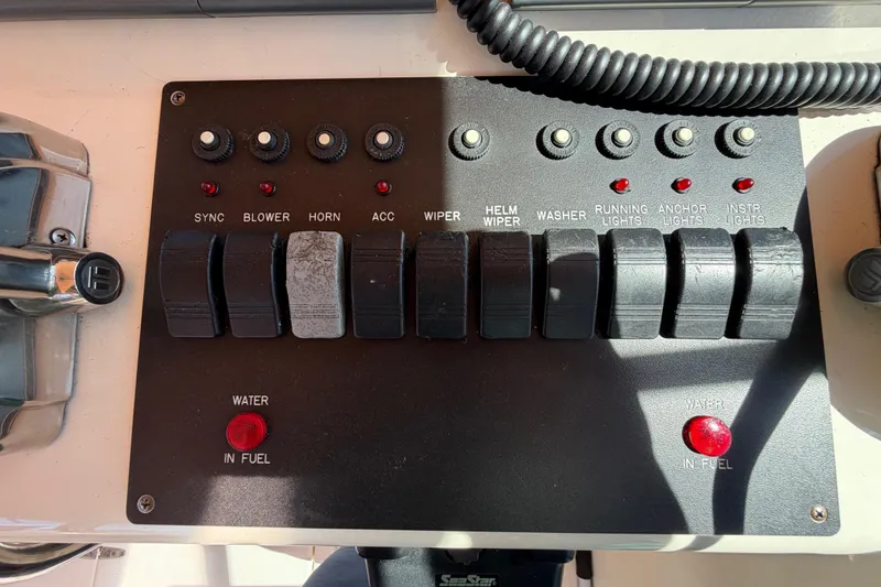 Slide: The Image of Control panel of a 2000 Sabreline 36 Express boat with various switches and indicators. - 37