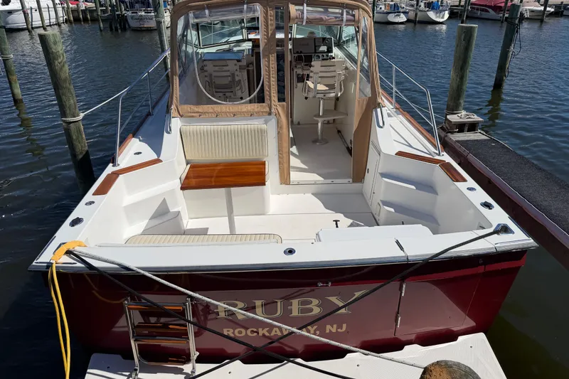 Slide: The Image of 2000 Sabreline 36 Express boat docked, featuring spacious seating and elegant design. - 50
