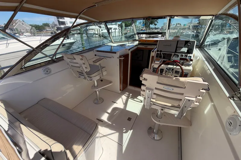 Slide: The Image of Interior of a 2000 Sabreline 36 Express boat with helm and seating area. - 9