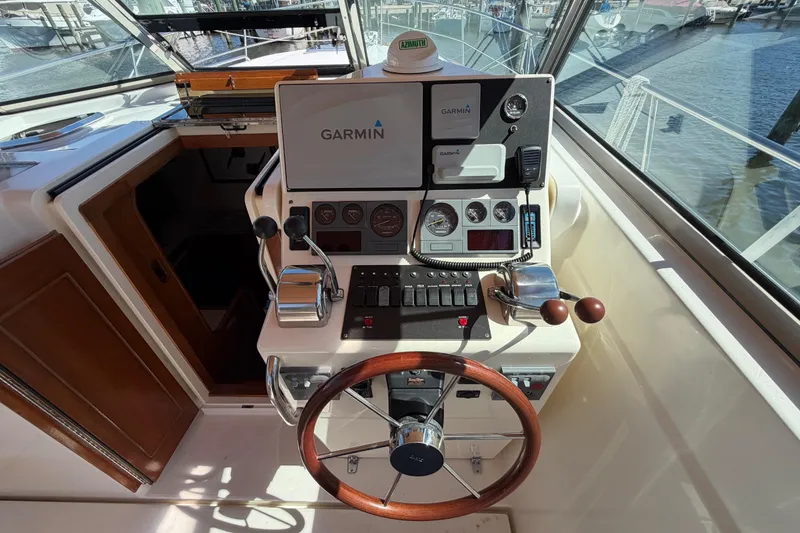 Slide: The Image of Helm of 2000 Sabreline 36 Express with Garmin navigation system and wooden steering wheel. - 12