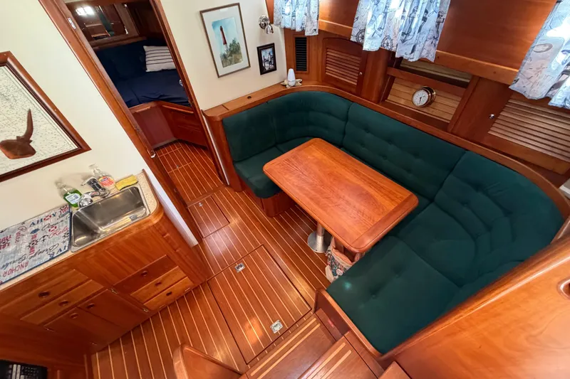Slide: The Image of Interior of 2000 Sabreline 36 Express yacht with wood finish and cozy seating area. - 15