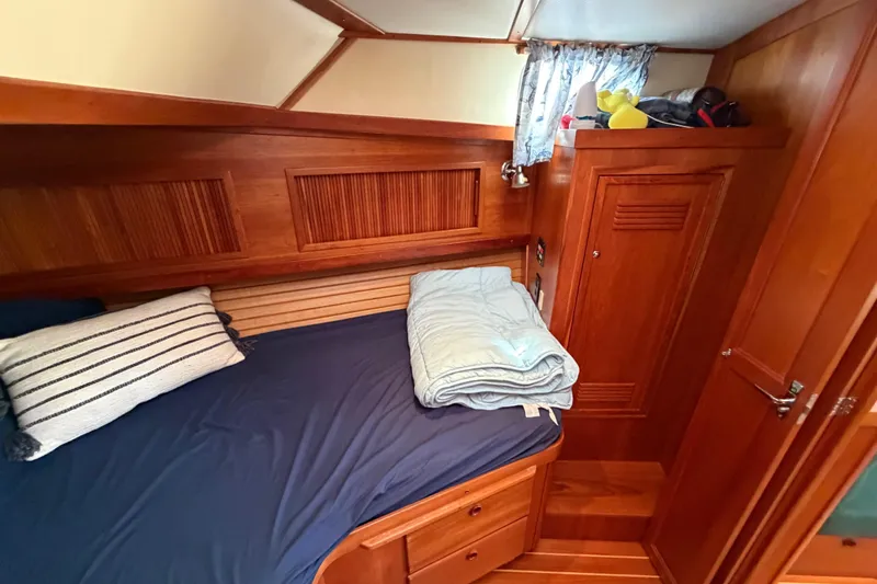 Slide: The Image of Cozy cabin interior of 2000 Sabreline 36 Express with wooden finish and bedding. - 21