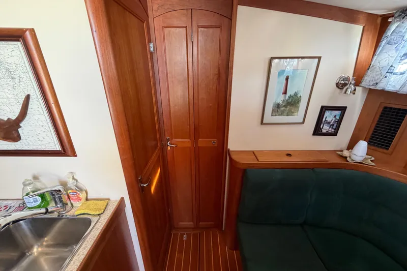 Slide: The Image of Interior of 2000 Sabreline 36 Express yacht with wood paneling and cozy seating area. - 25