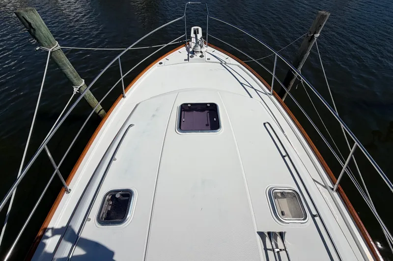 Slide: The Image of Bow view of 2000 Sabreline 36 Express yacht, docked with visible deck hatches. - 31