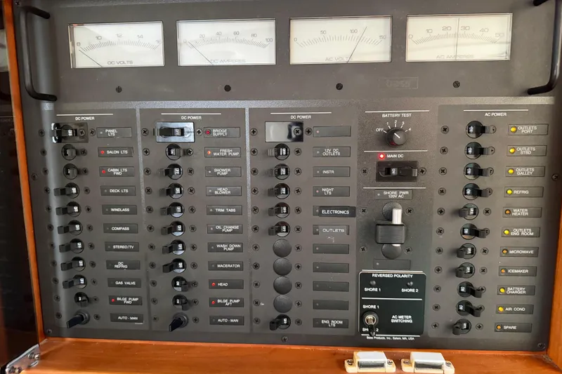 Slide: The Image of Electrical control panel of a 2000 Sabreline 36 Express boat, featuring various switches and meters. - 40