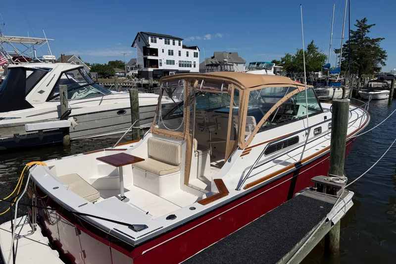 Slide: The Image of 2000 Sabreline 36 Express boat docked at marina, featuring sleek design and spacious deck. - 49