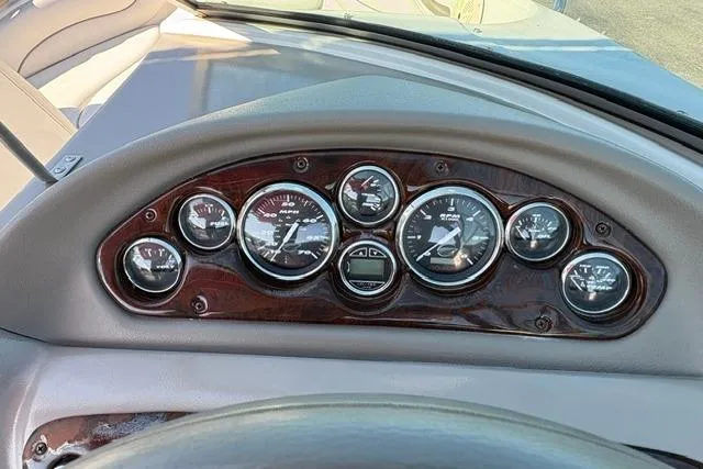 Slide: The Image of Dashboard of a 2003 Crownline 208 LX boat with multiple gauges and wood trim. - 39