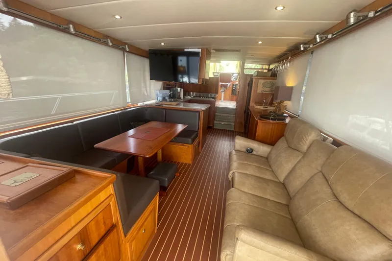 Slide: The Image of Luxurious interior of a 2002 Canoe Cove 50 Pilothouse Yacht with elegant seating and wood finishes. - 13