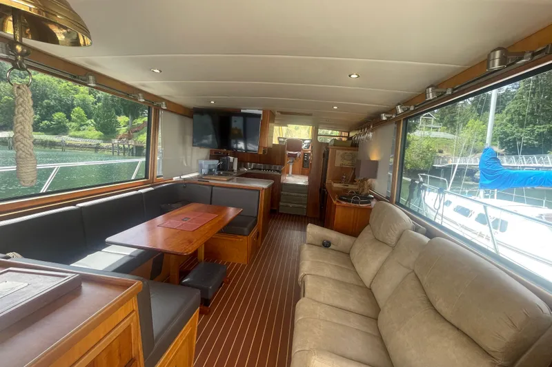 Slide: The Image of Luxurious interior of a 2002 Canoe Cove 50 Pilothouse Yacht with elegant seating and scenic views. - 14