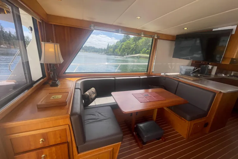 Slide: The Image of Luxurious interior of 2002 Canoe Cove 50 Pilothouse Yacht with scenic water view. - 15