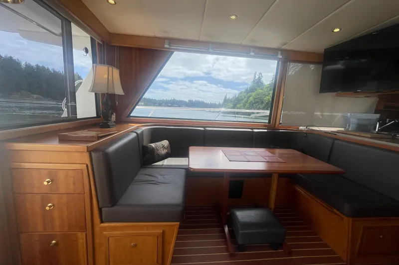 Slide: The Image of Luxurious interior of 2002 Canoe Cove 50 Pilothouse Yacht with scenic window view. - 17