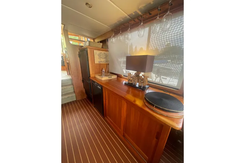 Slide: The Image of Luxurious interior of 2002 Canoe Cove 50 Pilothouse Yacht with elegant wood finishes. - 18