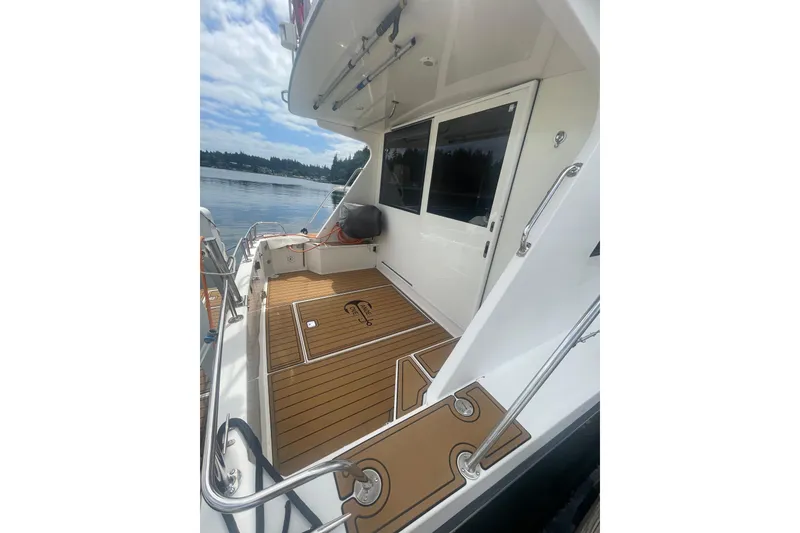 Slide: The Image of Canoe Cove 50 Pilothouse Luxury Yacht 2002, featuring spacious deck and sleek design. - 2