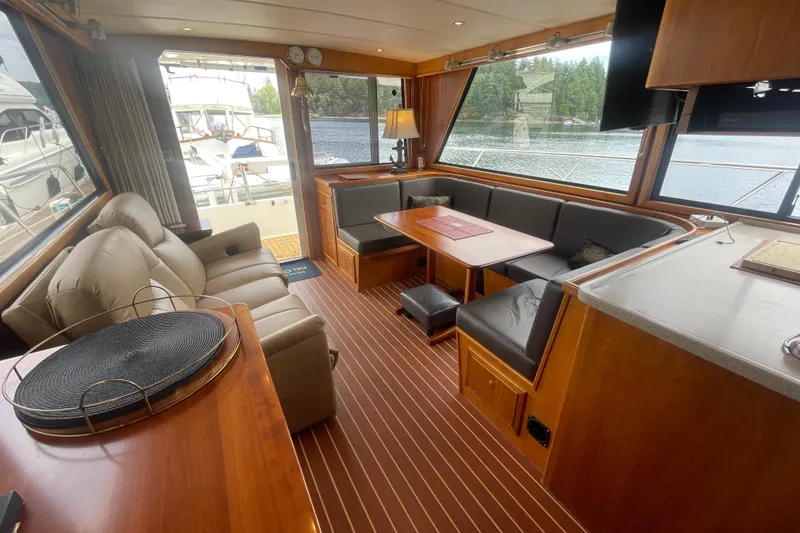 Slide: The Image of Luxurious interior of a 2002 Canoe Cove 50 Pilothouse Yacht with elegant seating and scenic views. - 25