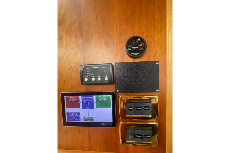 Slide: The Image of Control panel of a 2002 Canoe Cove 50 Pilothouse Luxury Yacht with various switches and displays. - 26