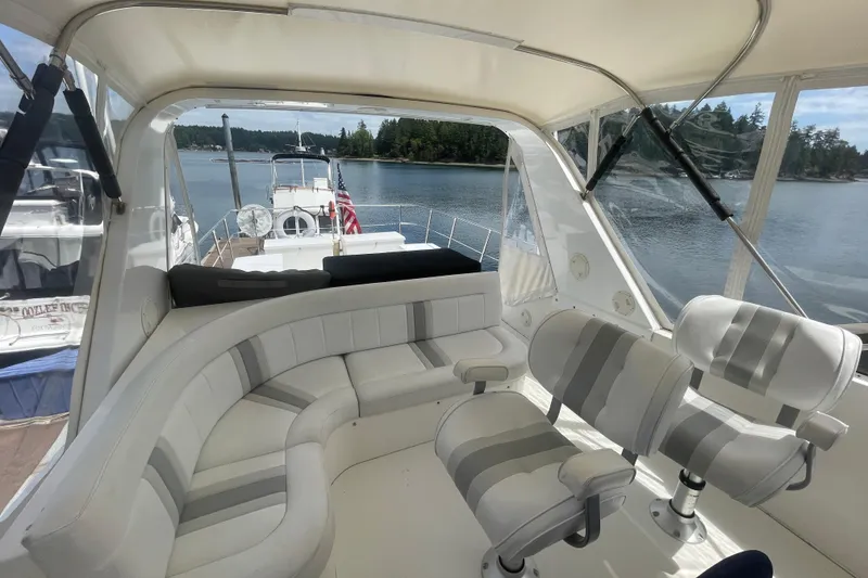 Slide: The Image of Luxurious interior of a 2002 Canoe Cove 50 Pilothouse Yacht with scenic water view. - 33
