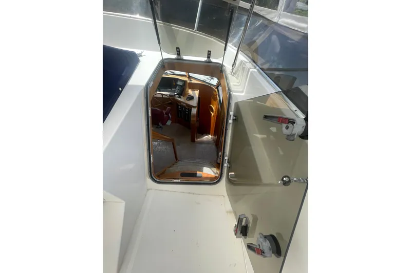 Slide: The Image of Interior view of 2002 Canoe Cove 50 Pilothouse Luxury Yacht, showcasing helm and cabin entrance. - 38