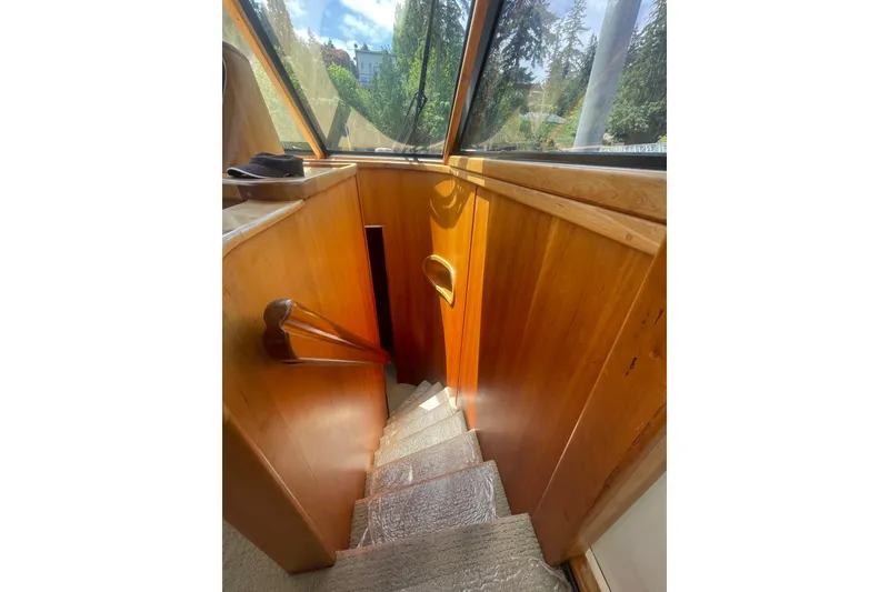 Slide: The Image of Staircase inside 2002 Canoe Cove 50 Pilothouse Luxury Yacht with wooden paneling. - 39