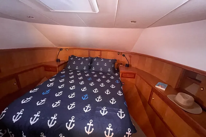 Slide: The Image of Luxurious bedroom in 2002 Canoe Cove 50 Pilothouse Yacht with nautical-themed bedding. - 40