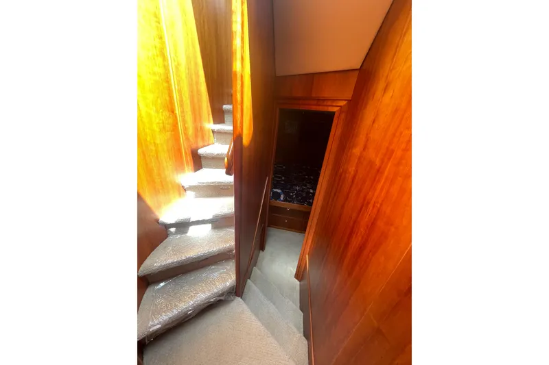 Slide: The Image of Interior staircase of 2002 Canoe Cove 50 Pilothouse Luxury Yacht with wooden paneling. - 47