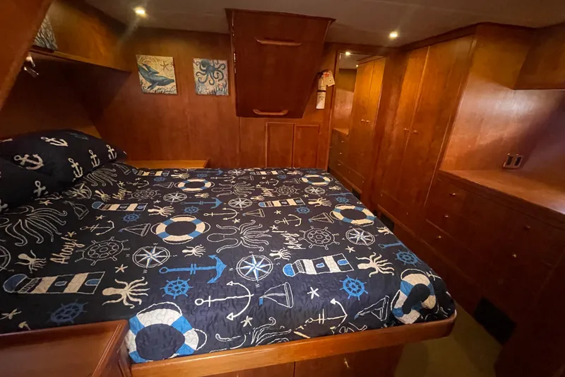 Slide: The Image of Luxurious bedroom in 2002 Canoe Cove 50 Pilothouse Yacht with nautical-themed bedding. - 48