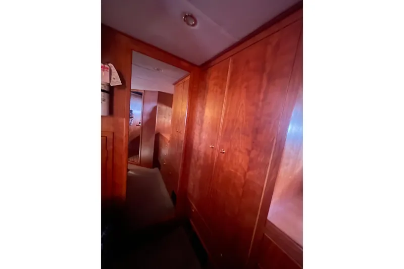 Slide: The Image of Interior hallway of 2002 Canoe Cove 50 Pilothouse Luxury Yacht with wooden cabinetry. - 49