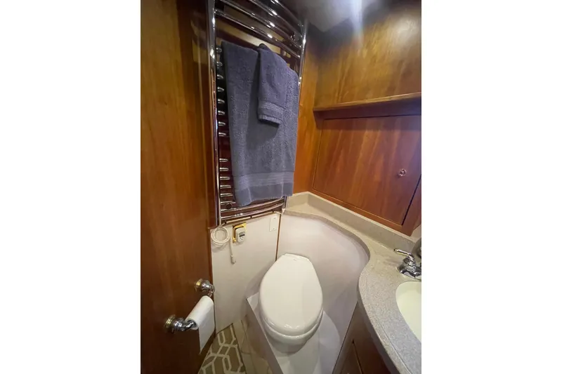 Slide: The Image of Luxurious bathroom in 2002 Canoe Cove 50 Pilothouse Yacht with wood paneling and modern fixtures. - 51
