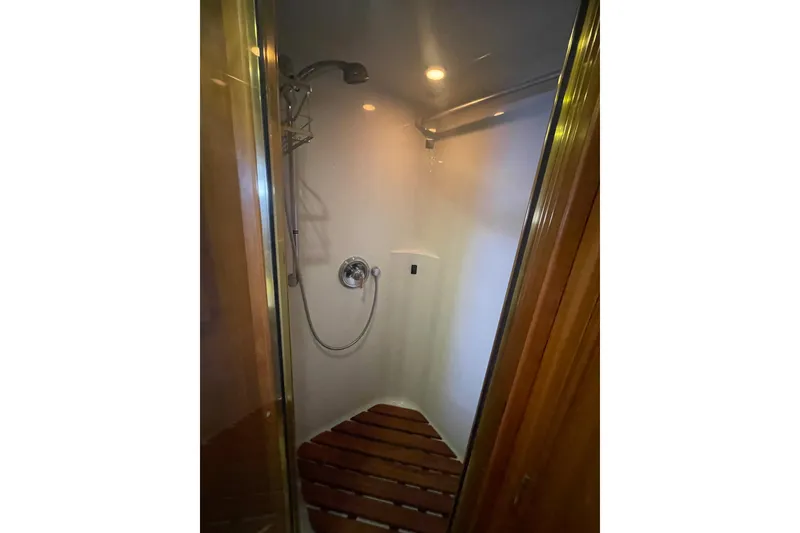 Slide: The Image of Shower area in 2002 Canoe Cove 50 Pilothouse Luxury Yacht with wooden floor slats. - 52