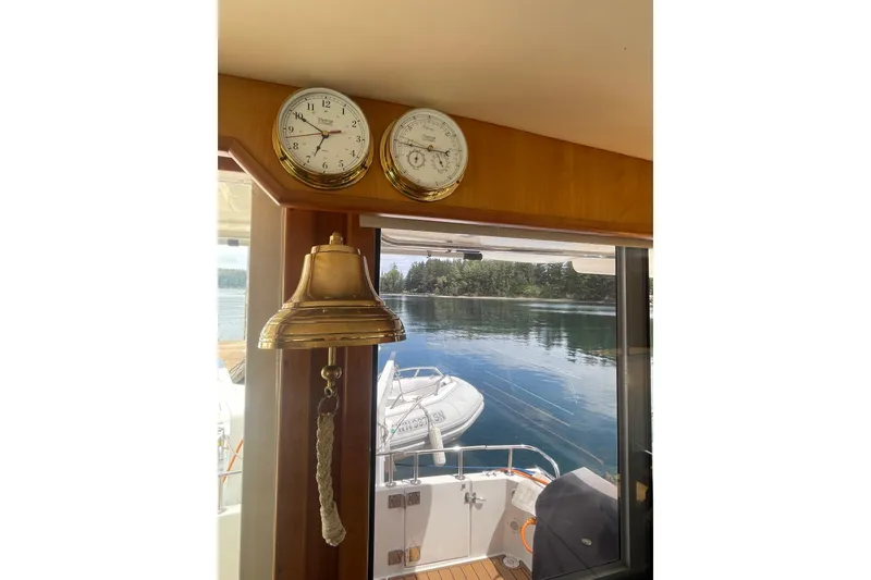 Slide: The Image of Interior view of 2002 Canoe Cove 50 Pilothouse Yacht with clock, barometer, and bell. - 53