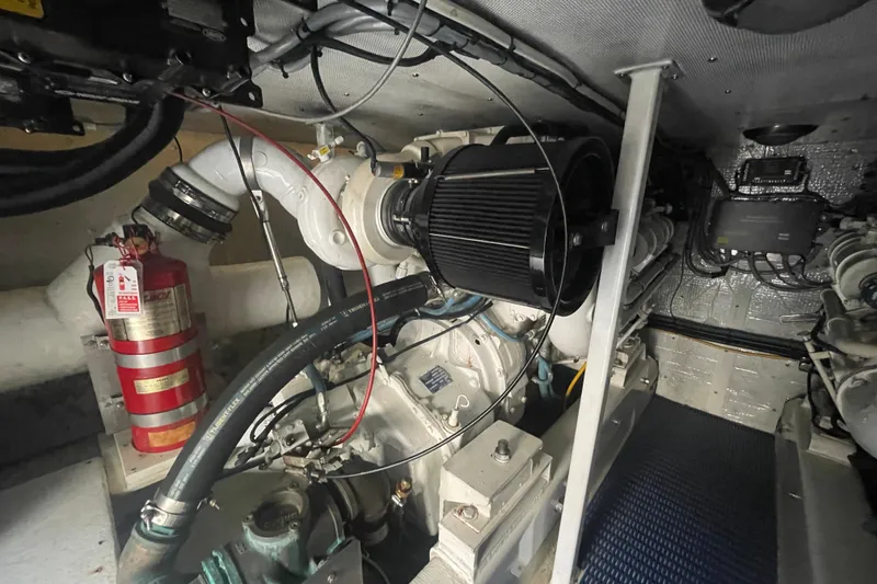 Slide: The Image of Engine room of 2002 Canoe Cove 50 Pilothouse Luxury Yacht with visible fire extinguisher. - 58