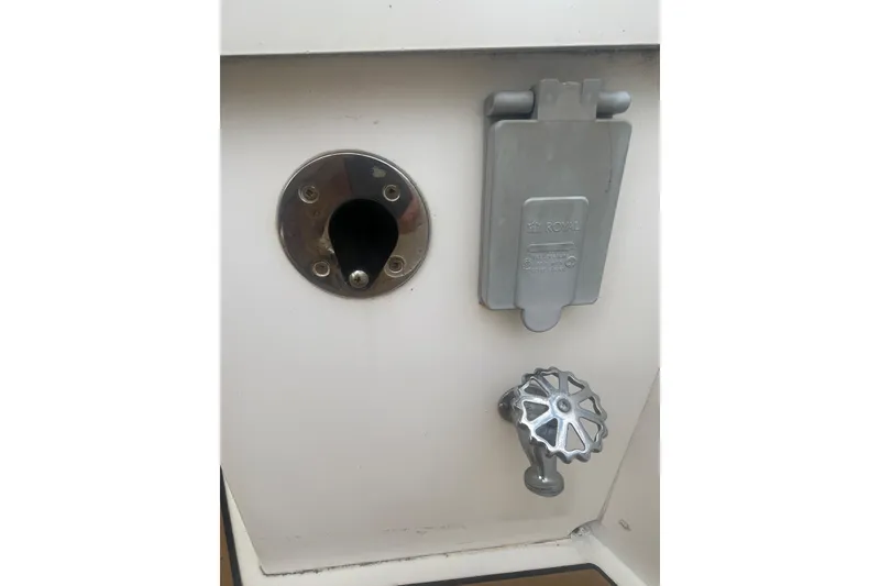 Slide: The Image of Close-up of a 2002 Canoe Cove 50 Pilothouse Yacht's utility panel with valve and outlet. - 9