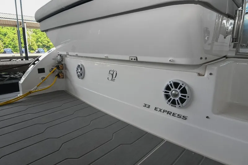 Slide: The Image of 2021 Regal 33 Express boat stern with speakers and power connections. - 12