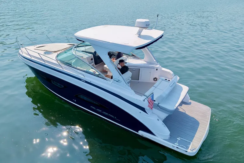 Slide: The Image of 2021 Regal 33 Express boat cruising on calm blue water, featuring sleek design and spacious deck. - 13