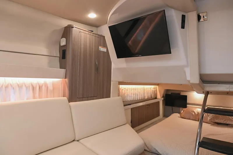Slide: The Image of Interior of 2021 Regal 33 Express yacht with modern furnishings and mounted TV. - 46