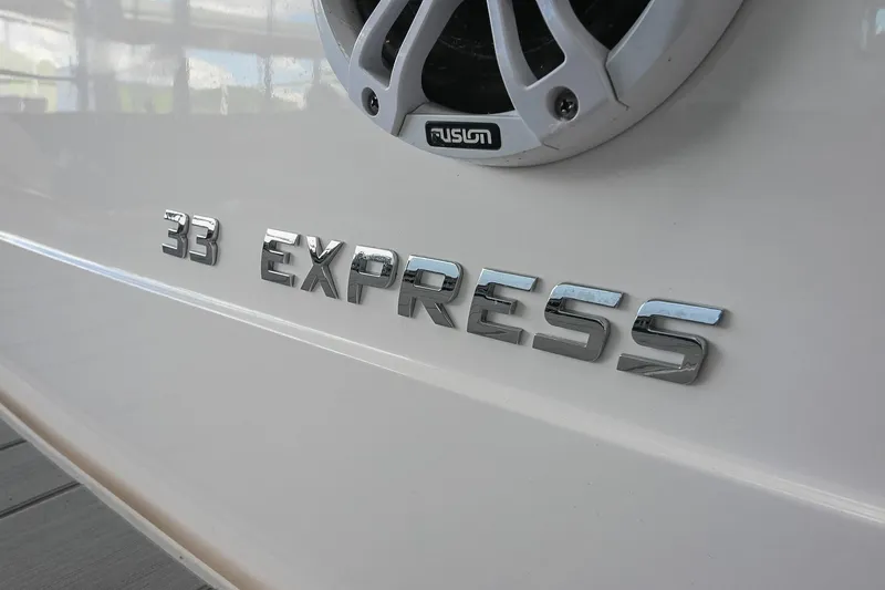 Slide: The Image of 2021 Regal 33 Express boat nameplate with Fusion speaker detail. - 6