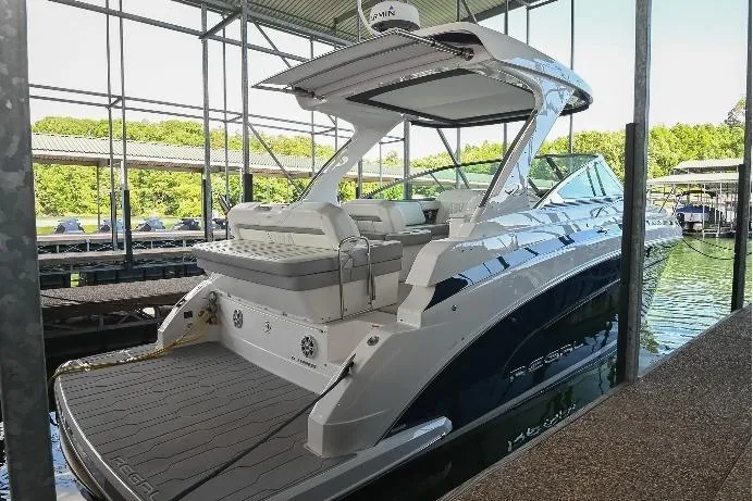 Slide: The Image of 2021 Regal 33 Express boat docked in a marina, showcasing sleek design and modern features. - 66