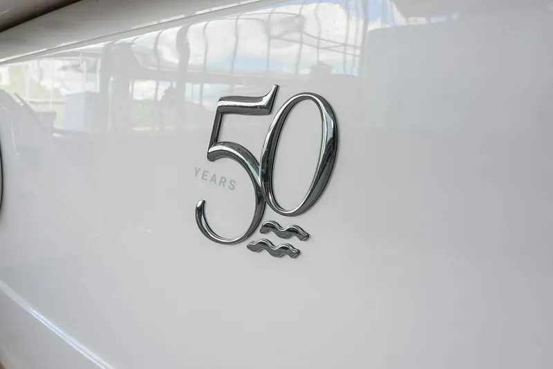 Slide: The Image of Regal 33 Express 2021 boat, 50th anniversary emblem on white hull. - 7