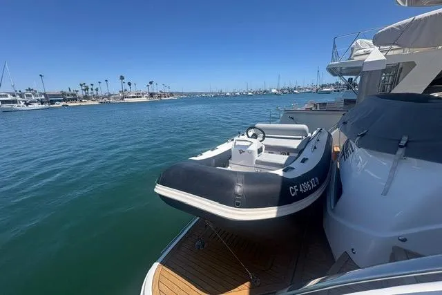 Slide: The Image of 2024 Williams Jet Tenders 345 Sports Jet docked on a yacht in a sunny marina. - 5